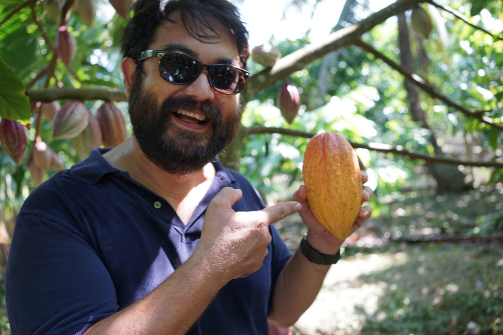 sam with a ripe cacao pod marou chocolate